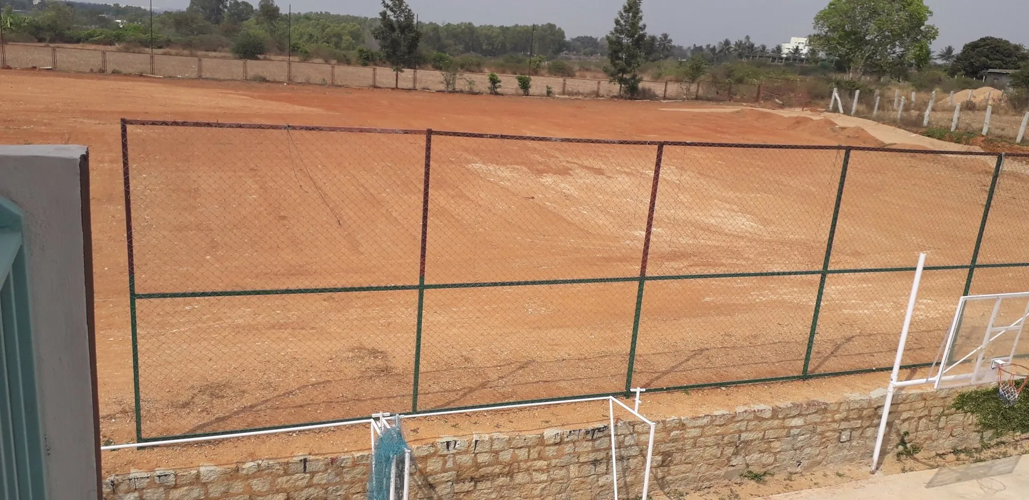 The school playing field behind its new fence